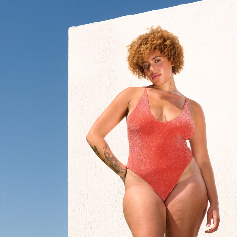 one-piece swimsuit with glitter and tie strings;